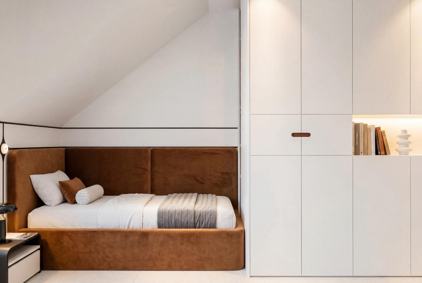 Warm finished bedroom interior with built-in cabinetry